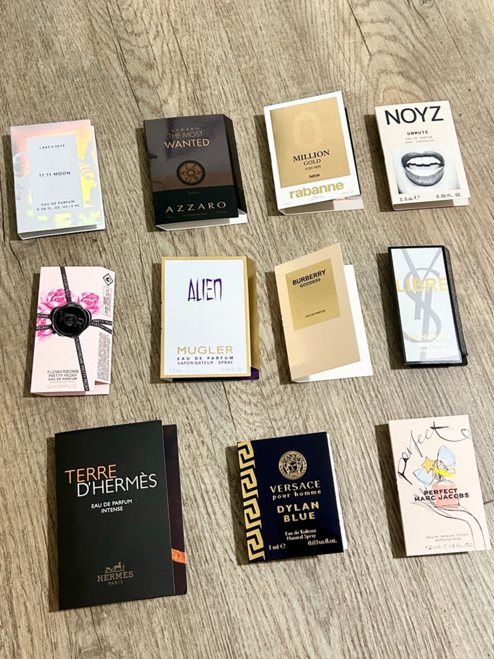Bundles of 11 assorted brand name perfume samples.